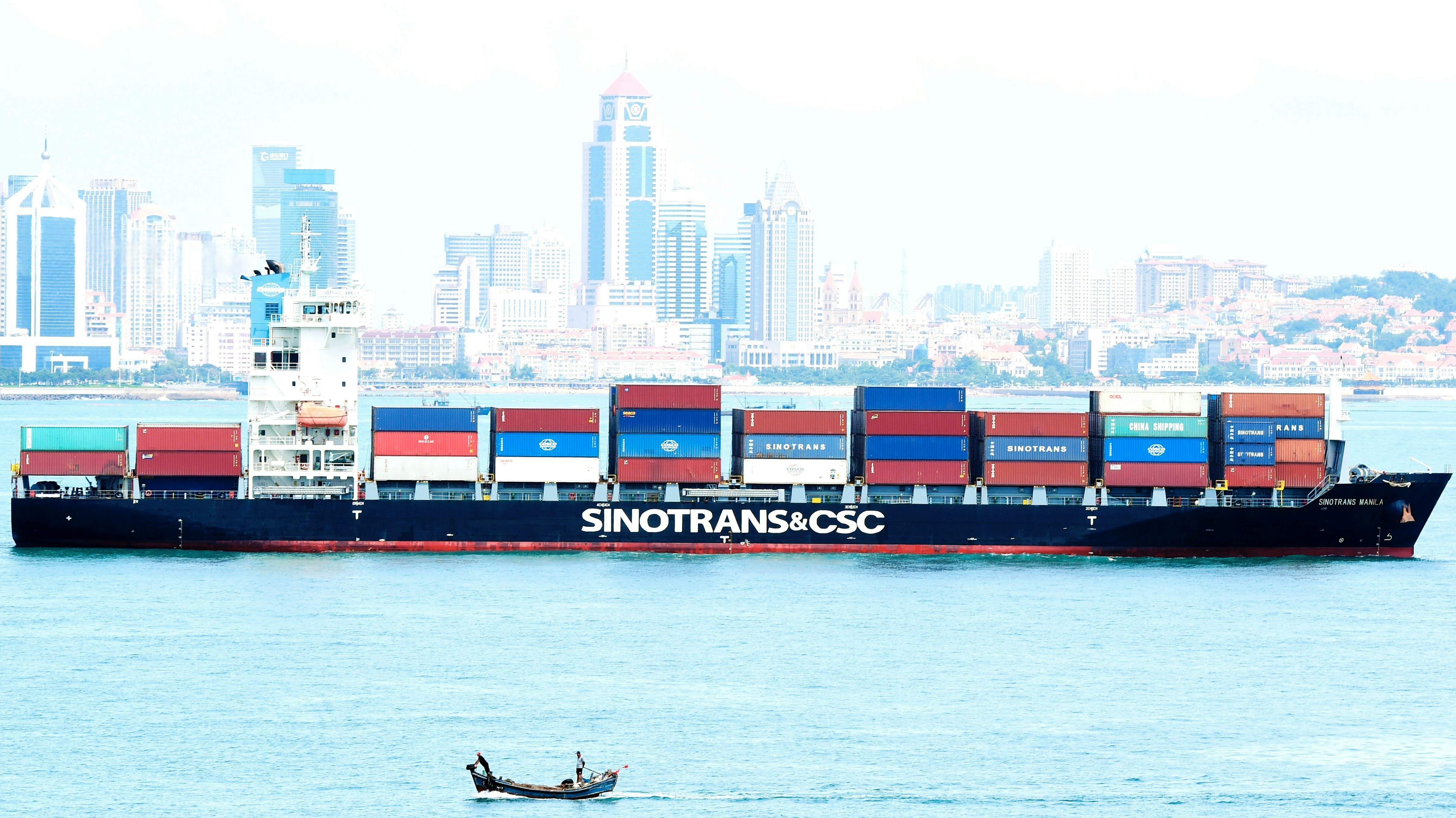 A container ship sailing past the city of Qingdao in east China's Shandong province last month. Photo by AP.