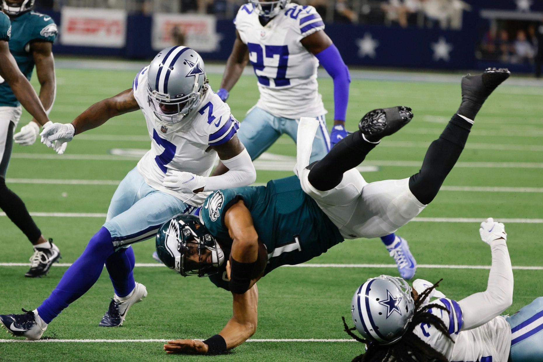 Dallas Cowboys' Trevon Diggs (7) and Maurice Canady, right, combine to stop Philadelphia Eagles quarterback Jalen Hurts, center, during an NFL football game Monday. Photo: AP