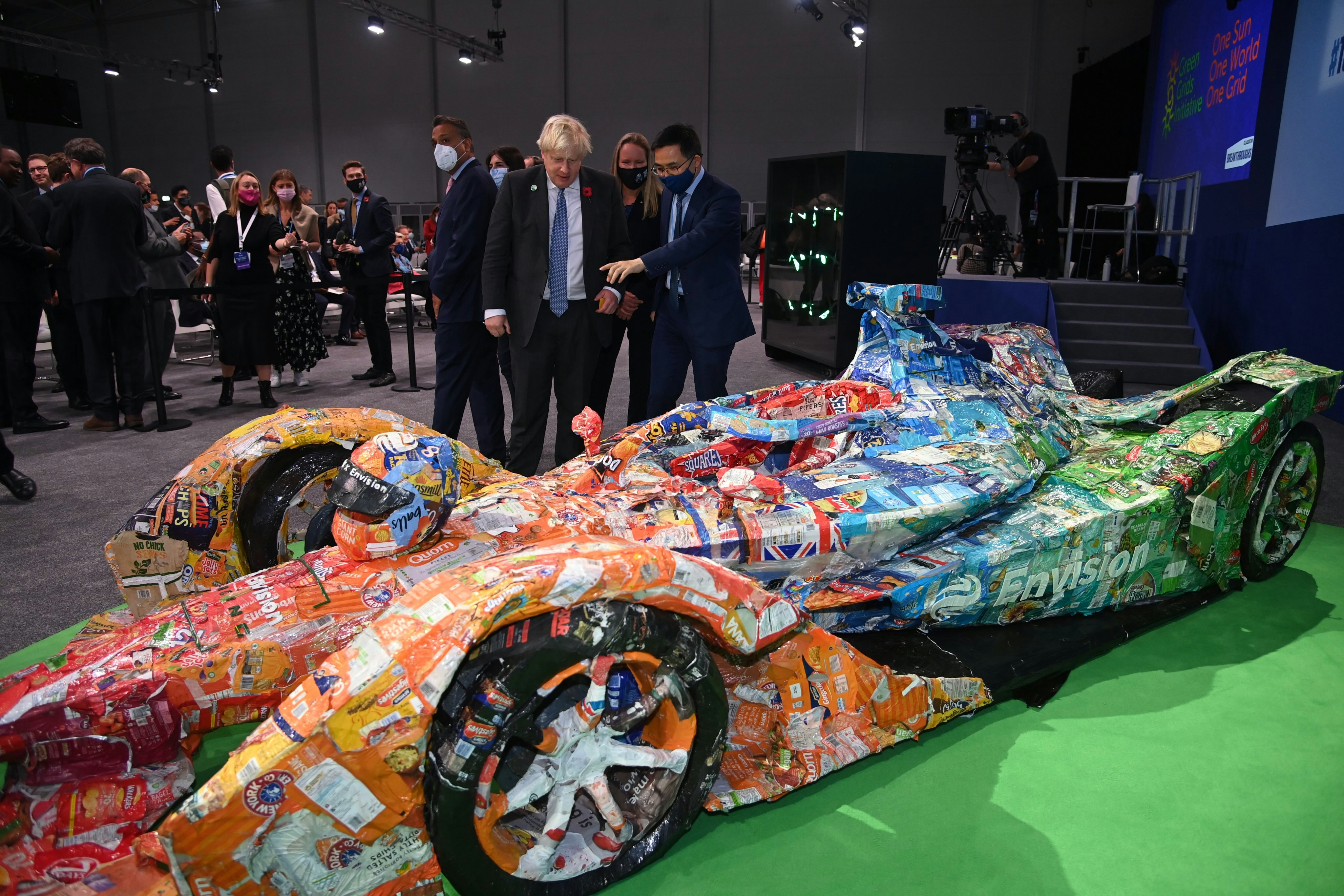 At COP26, British Prime Minister Boris Johnson with Envision Virgin Racing's Formula 1 race car containing Johnson Matthey's eLNO battery. Photo: Courtesy Envision Racing