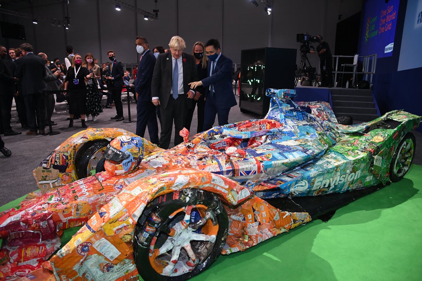 At COP26, British Prime Minister Boris Johnson with Envision Virgin Racing's Formula 1 race car containing Johnson Matthey's eLNO battery. Photo: Courtesy Envision Racing