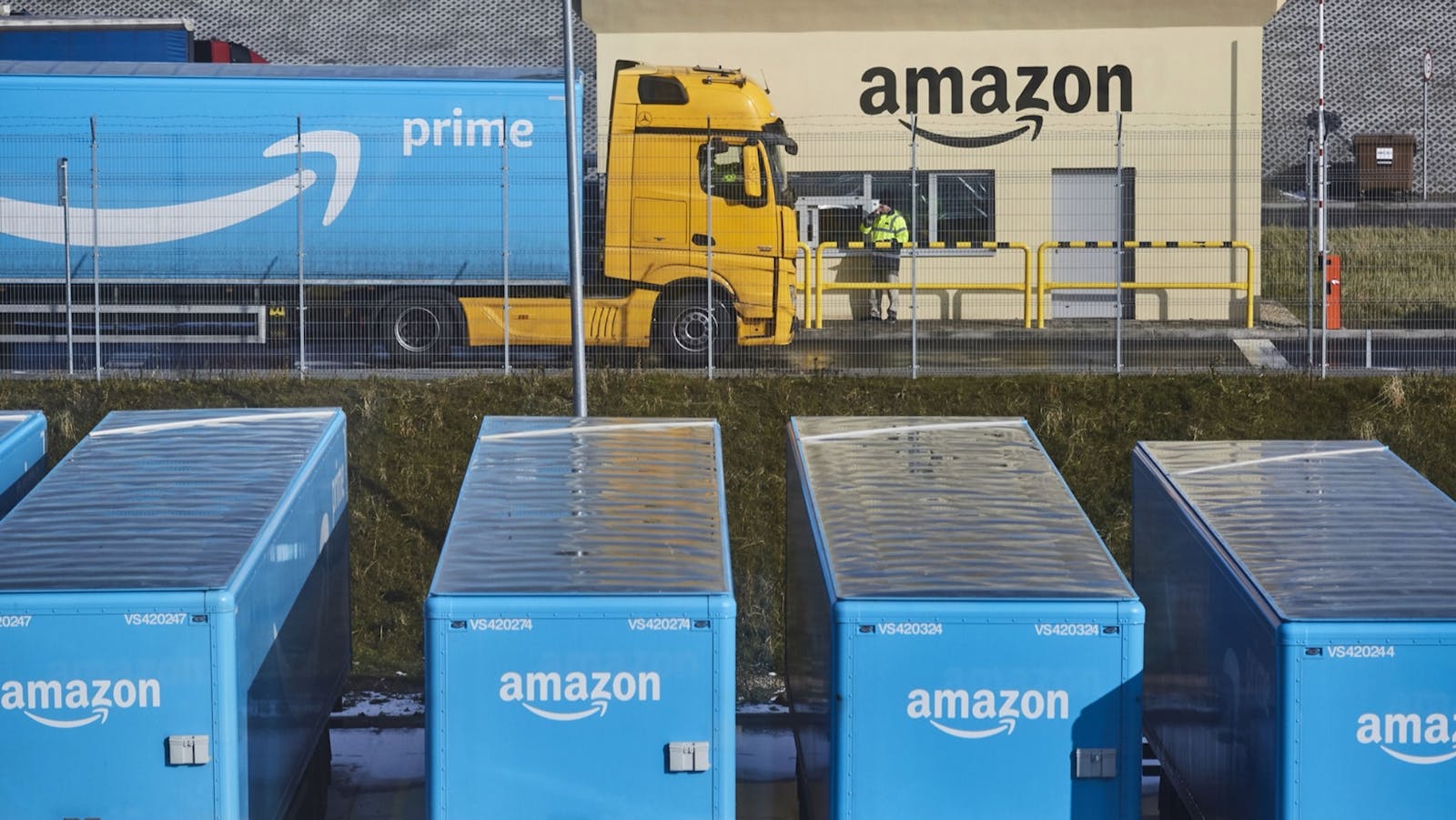 Amazon trailers at the entrance to an Amazon warehouse in Kolbaskowo, Poland, in 2018. Photo by Bloomberg