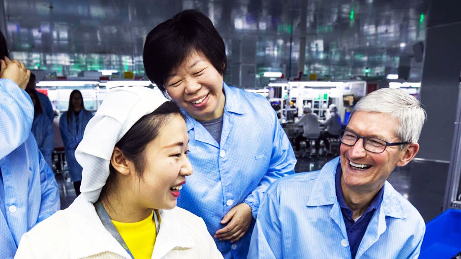 Apple CEO Tim Cook at an AirPods production line with Luxshare CEO Grace Wang (standing behind Cook) in 2017. Photo by Luxshare