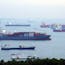 Container ships and bulk carriers offshore from Singapore. Photo by Bloomberg