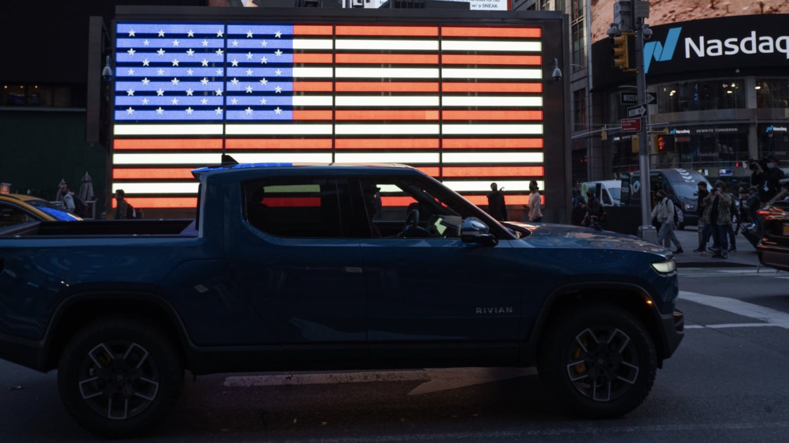 A Rivian truck driving past the Nasdaq in New York the day of Rivian's IPO. Photo by Bloomberg.
