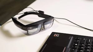 The ThinkReality A3 enterprise AR glasses, seen here cabled to a PC laptop. Credit: Lenovo.