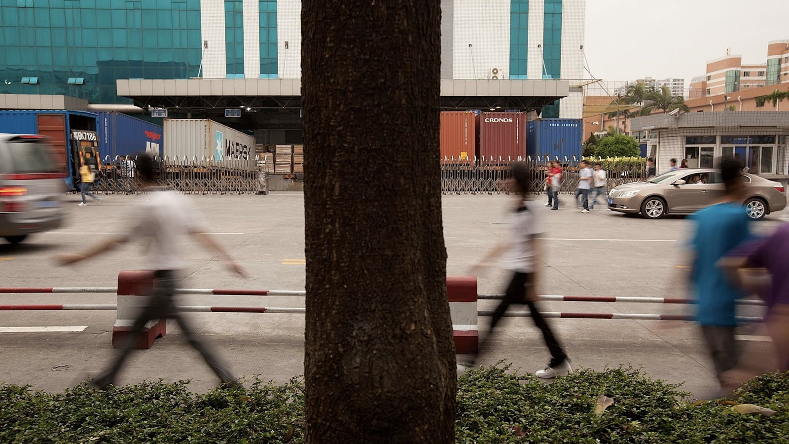 Foxconn employees walking past a company facility in Shenzhen. Photo by Bloomberg.