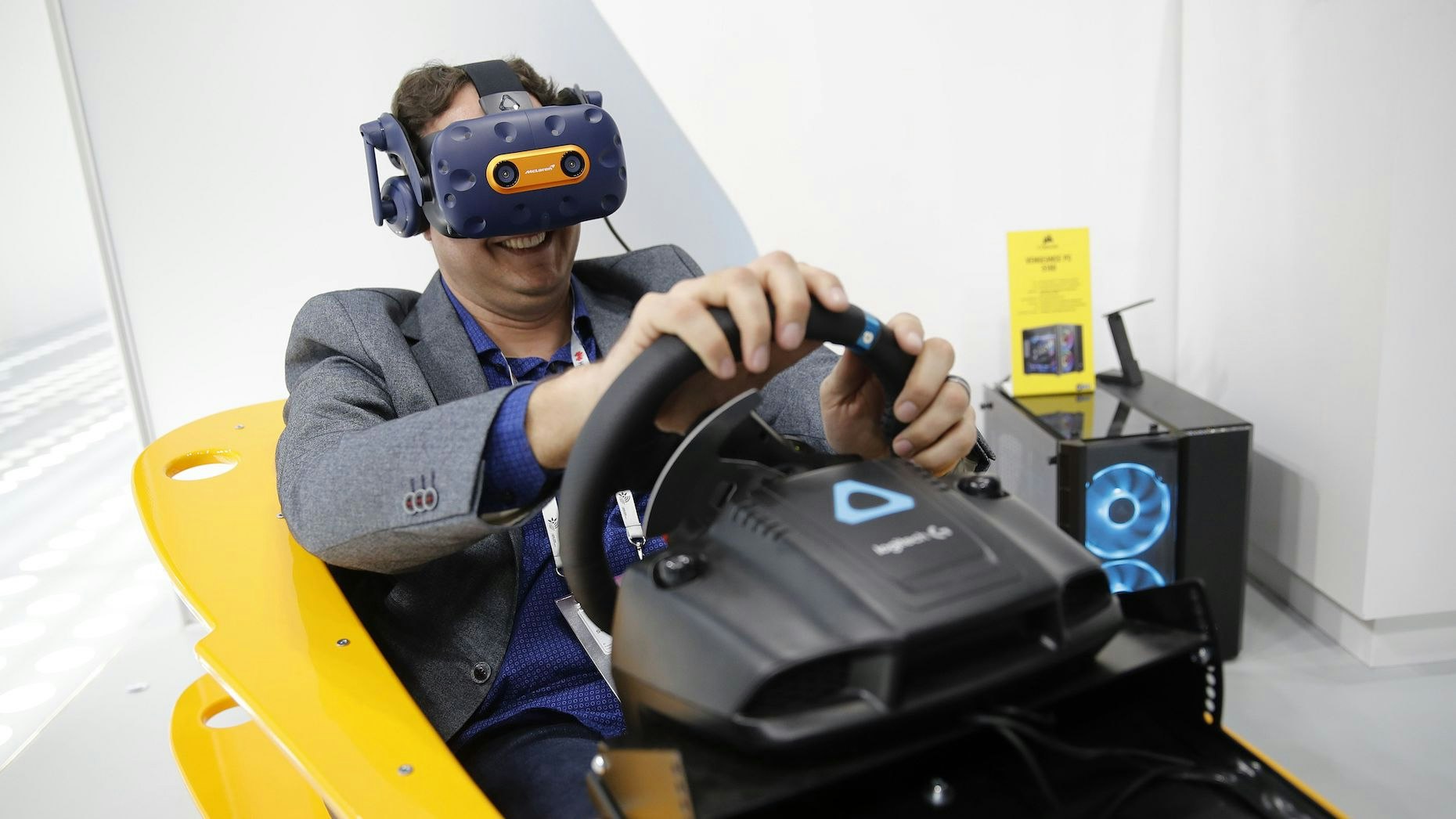 A person using an HTC Vive headset to play a VR racing simulator. Photo: Bloomberg.
