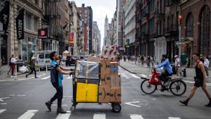 A worker delivers packages on Amazon Prime Day in New York. Photo: Bloomberg.