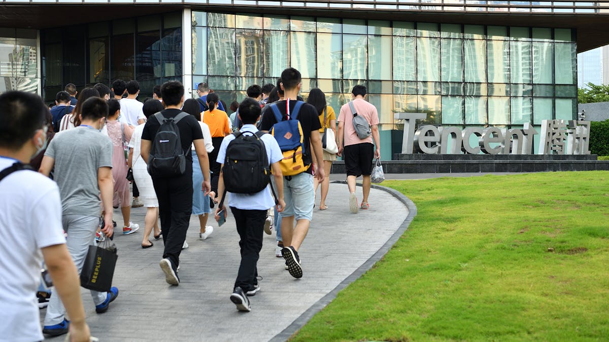 Employees walking outside the Shenzen headquarters of Tencent. Photo by Getty