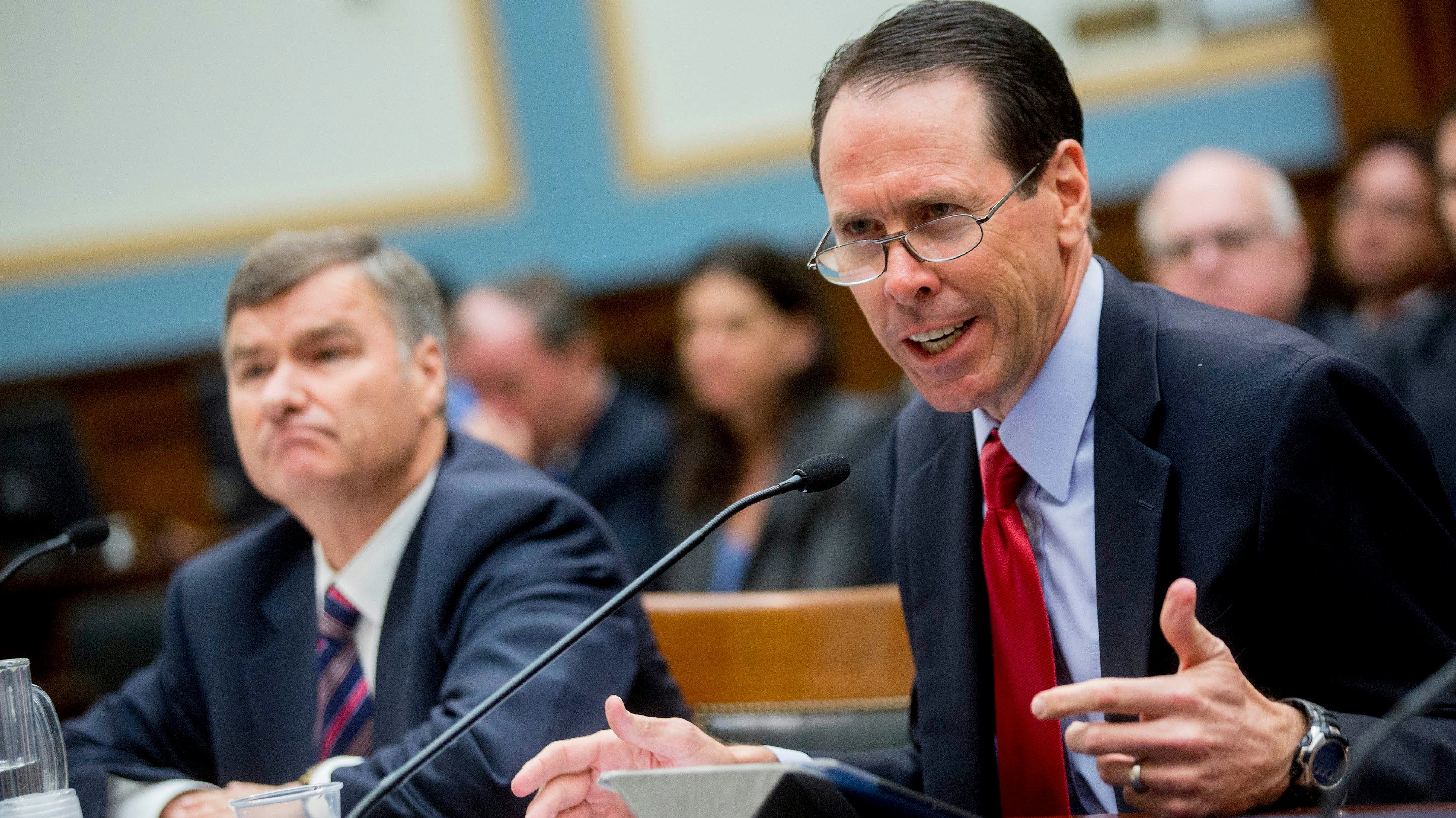 DirecTV's former CEO Mike White, left, with AT&T CEO Randall Stephenson. Photo by Bloomberg.